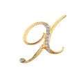 Golden letter K brooch featuring clear crystals and polished metal finish on white background - Letter X / Gold