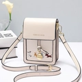 Cream mini crossbody bag with colorful dog embroidery and adjustable strap in studio view - Off-white