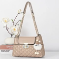 Detail of beige quilted shoulder bag featuring gold chain strap and T-bar twist lock - Khaki