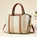 Fashionable straw woven handbag with brown leather straps and striped design - Khaki