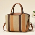 Detail of a vintage striped tote bag with leather straps and gold metal hardware - Earthy Yellow