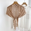 Detailed view of brown hollow-out crochet lace shawl with floral pattern and front tie - Camel
