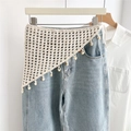 Detail view of beige crocheted cotton triangle scarf with fringe beads on blue jeans - Style 3 Wood Bead Lattice