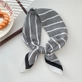Black and white striped silk neck scarf tied in a stylish knot on a white surface - Arrow Fine Stripe Milk White (34SR)