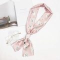 Pink silk-like long scarf with white swan print styled as a bow on white background - Swan Pink