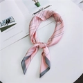 Sciarpa di seta rosa con linee geometriche grigie mostrata in uno stile annodato - Linea Grigia Rosa