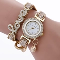 Golden alloy fashion watch for women with rhinestone LOVE bracelet and hanging charm - Gold