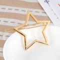 Hollow gold star hair clip with polished metallic finish and spring grip closure - Gold (B8203)