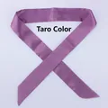 Close-up of mauve narrow satin scarf tied in a bow on a plain light grey background - 100x4cm / Taro