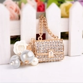 Golden rhinestone purse keychain with decorative pearl and flower charms on white background - Pearl Small Handbag