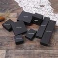Elegant black kraft jewelry boxes for rings and necklaces on a rustic dark wood desk - 17.5x4.5x3.3cm