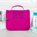 Hanging magenta toiletry bag with large capacity and mesh pockets on white sink - Rose Red