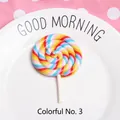 Macro detail of large colorful spiral clay lollipop model in a white ceramic dish - Rainbow Style 3