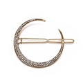 Macro shot of vintage gold crescent moon hair clip with sparkling crystal inlay details - Gold Moon