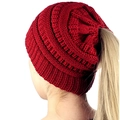 Red knit ponytail beanie for women with a functional opening shown on a model - Red