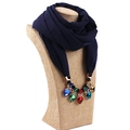 Close-up of navy blue chiffon scarf with colorful gemstone pendant on a display bust - Navy Blue