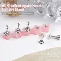 Macro view of pink agate resin nail art practice stand with magnetic metal holders - Pink Faux Agate