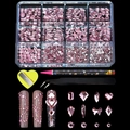 Macro detail of 12-slot nail art kit with pink rhinestones, tweezers and dotting tools - 12 Grids Pink Rhinestone Set