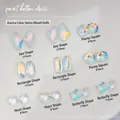 Macro shot of K9 aurora glass nail crystals in assorted shapes on white background - Axe/Long Strip/Square/Heart/Butterfly Mixed / Aurora AB (K9 Series 05)