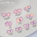 Detail view of pink Aurora Aurora glass crystals in mixed shapes for nail art sets - Asymmetric Heart/Square/Axe/Fat Square/Teardrop Mixed / Transparent Pink Aurora (K9 Series 06)