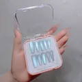 Detailed view of light blue cat eye press-on nails in a pink storage box - Handmade Custom Cat Eye Press On Nails 12