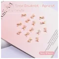 Detail of 8x4mm apricot ribbon bow nail charms with central pearl for DIY manicure - Apricot Bowknot (2506)