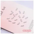 Close-up of 8x3.5mm white bowknot nail charms with center pearl bead for DIY nail art - White Bowknot (2508)