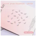 Detailed close-up of 6x3mm white bowknot nail art charms with a center pearl bead - White Bowknot (2510)