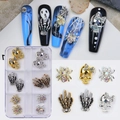 Detail of Halloween nail charms with metallic skulls and spiders in a storage box - 6-Grid Halloween Nail Art Ornament Box