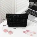 Quilted black cosmetic bag with soft padded texture and dimensions 20cm x 14cm - Black