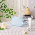 Light blue mesh toiletry bag with wide handle on a pink checkered tablecloth - Small / Blue