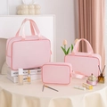 Pink 3-piece waterproof cosmetic bag set with mesh texture and portable handles - Three-Piece Set / Pink