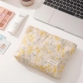 Linen makeup bag with yellow floral embroidery and H&R BAG label on desk - Large Beige Linen Floral Embroidery