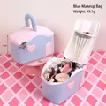 Blue and pink house-shaped cosmetic bag with heart patch showing interior storage space - Blue