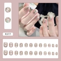 Detail of short round silver glitter press-on nails set with red and gold dots - R377 Sparkly Champagne Glue Style