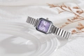 Detail of square purple dial watch with Roman numerals and silver metal link strap - Purple