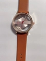 Detailed macro view of the skeleton dial and rose gold case of this TOMI quartz watch - Brown Strap Gold Dial