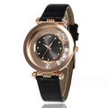 Detail of rose gold watch case with floating crystals and black sunray dial texture - Brown