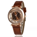 Close-up of rose gold watch featuring a brown leather strap and floating dial crystals - Red