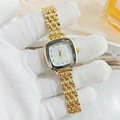 Detailed close-up of a women's luxury square gold watch with diamond markers - Gold