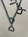 Macro shot of iridescent heart pendants on a chunky punk style Cuban link chain - Multicolor 78cm
