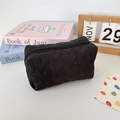 Detail of heart-quilted texture on soft black large capacity cosmetic storage bag - Quilted Heart Black