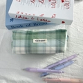Detail of checkered pencil case with logo label and aesthetic stationery background - Green Plaid (Sparkle)