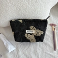 Detailed embroidery of gold butterflies on a black satin cosmetic bag with brand logo - Gold Thread Butterfly Medium Cosmetic Bag