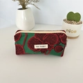 Detailed embroidery of dark red orchids on a green fabric pencil case with a zipper - Pomegranate Flower / Pencil Case