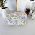 Macro detail of quilted floral makeup bag with blue flowers and beige zipper closure - Blue Flower