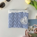 Detailed view of heart-quilted blue striped pouch with lace trim and pearl zipper - Crepe Striped Heart Blue