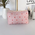 Detailed view of quilted pink makeup bag with red heart pattern and zipper closure - Vertical Stripe Pink Heart