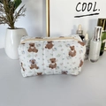 Detailed macro of the soft quilted texture and cute bear floral patterns on the cosmetic bag - Cartoon Bear