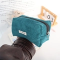 Detail of teal corduroy pouch showing textured fabric and silver ring zipper pull - Dark Green